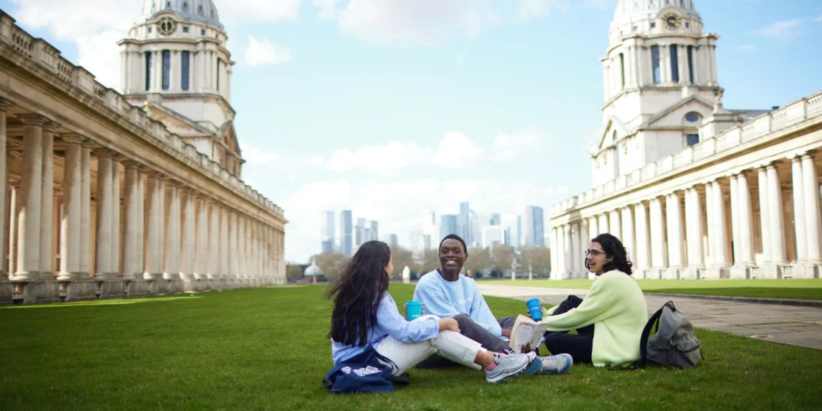 A group of people sitting on the grassDescription automatically generated